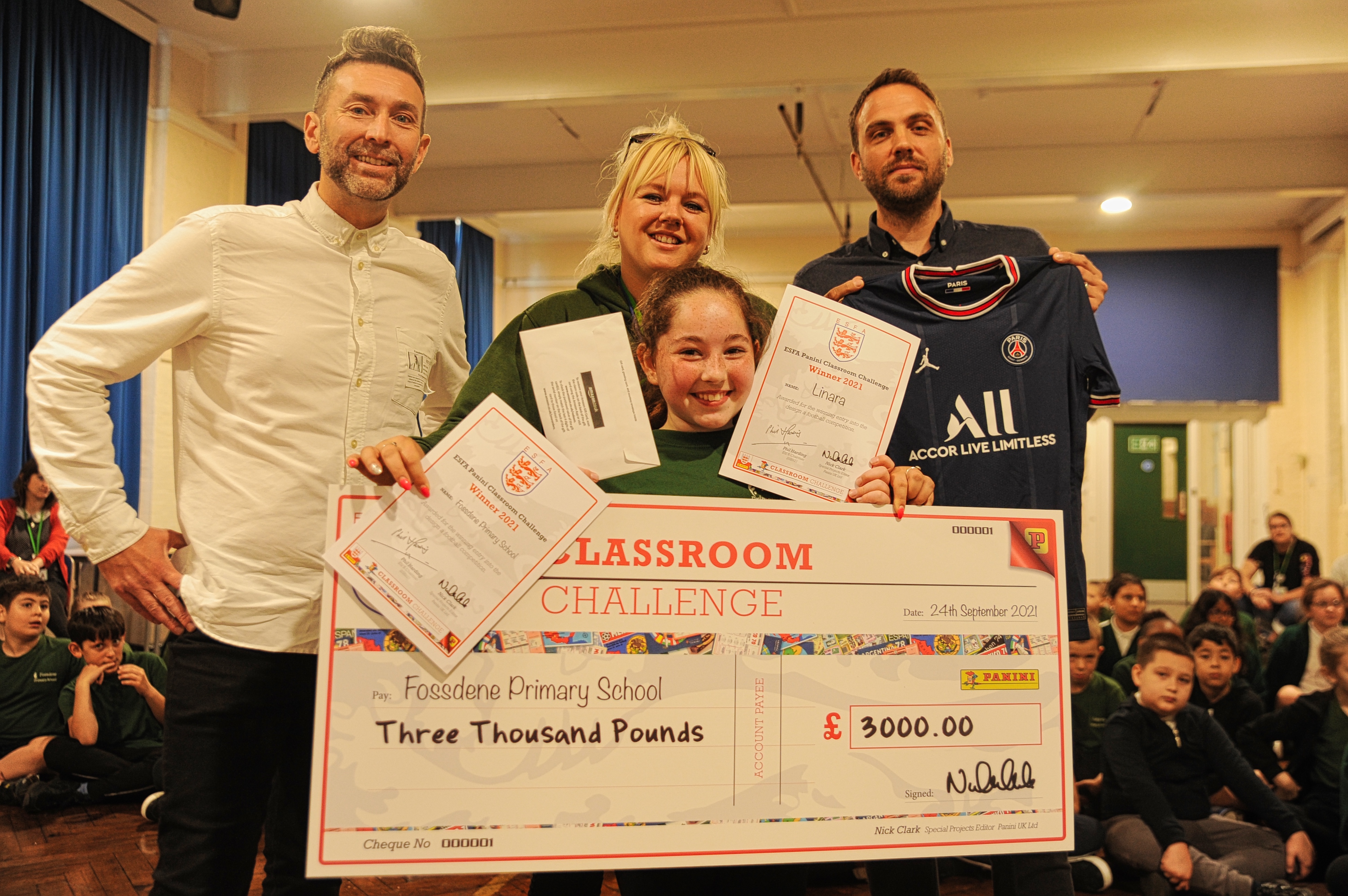 Former Classroom Challenge winners from 2021, posing with a giant cheque
