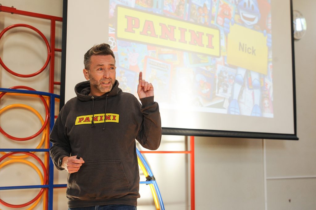 Nick Clark from Panini standing in front of a screen whilst giving a presentation to pupils at Stoke Poges school