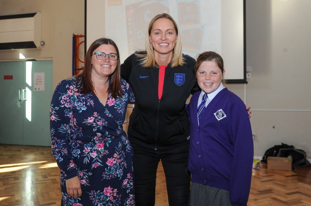 Faye White posing with a pupil and the Headteacher from Stoke Poges school